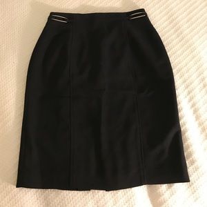 Black pencil skirt with metal detail at waist